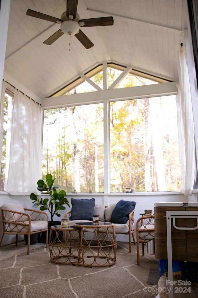 sunroom with vaulted ceiling, a wealth of natural light, and ceiling fan