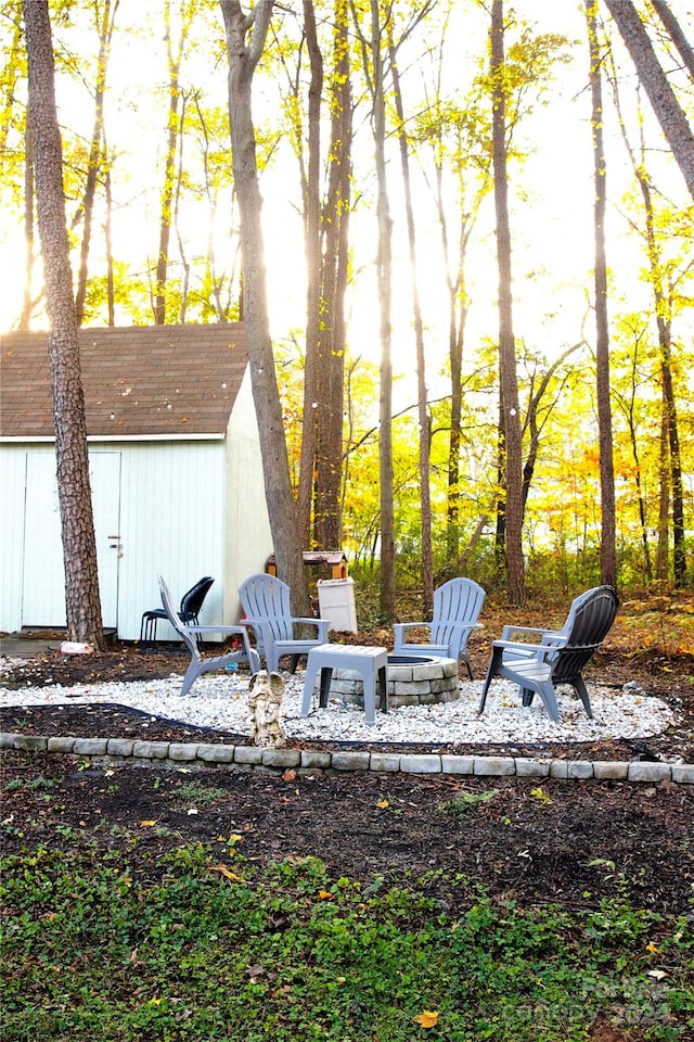 view of yard with a fire pit and a storage unit