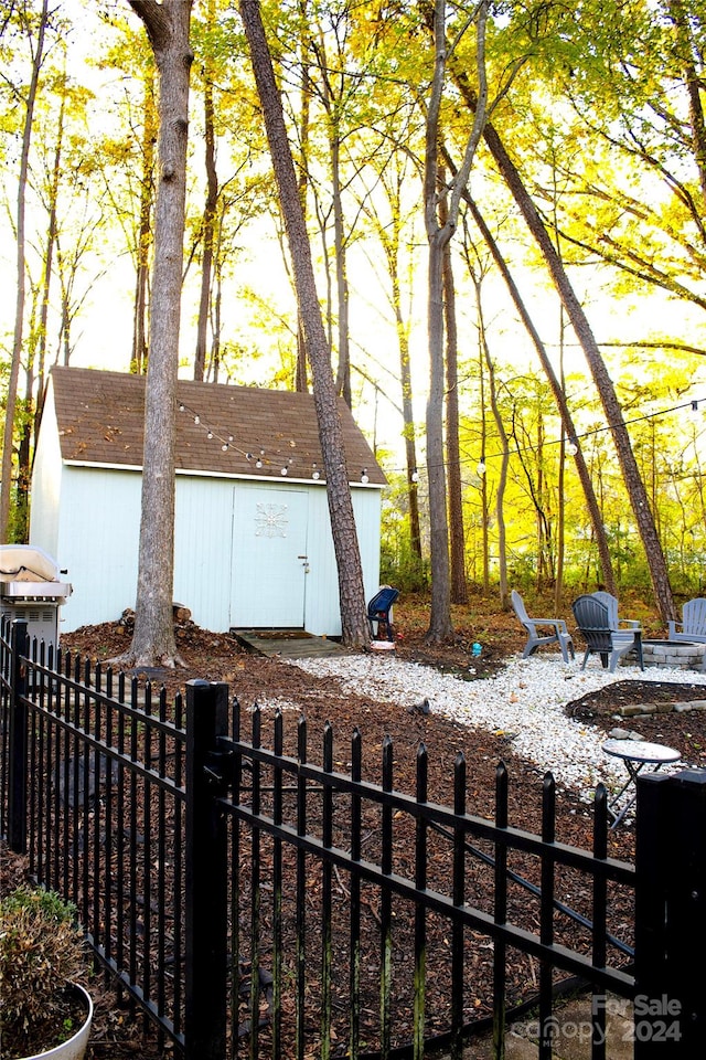 view of side of home featuring a shed