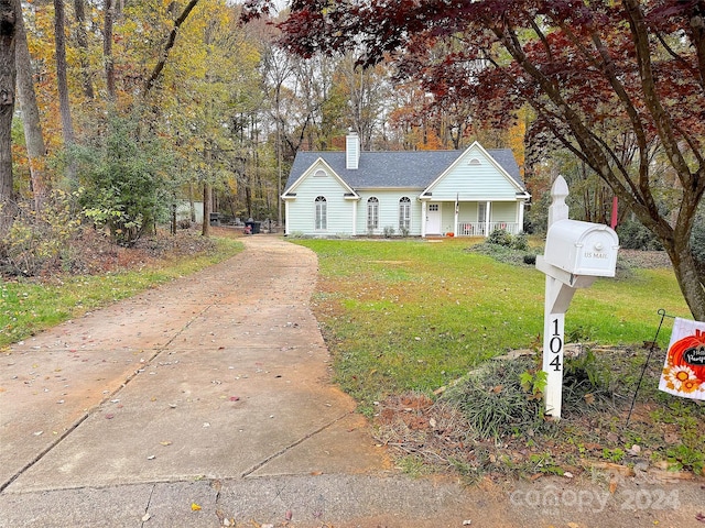 view of front of property with covered porch and a front yard