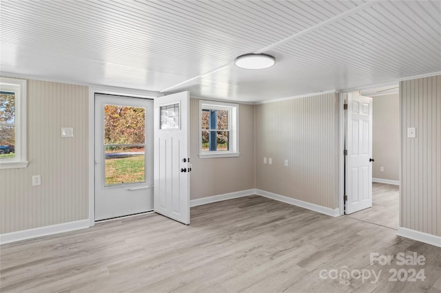 entryway featuring light hardwood / wood-style flooring and wood walls