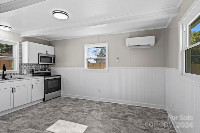 kitchen featuring appliances with stainless steel finishes, backsplash, plenty of natural light, and sink