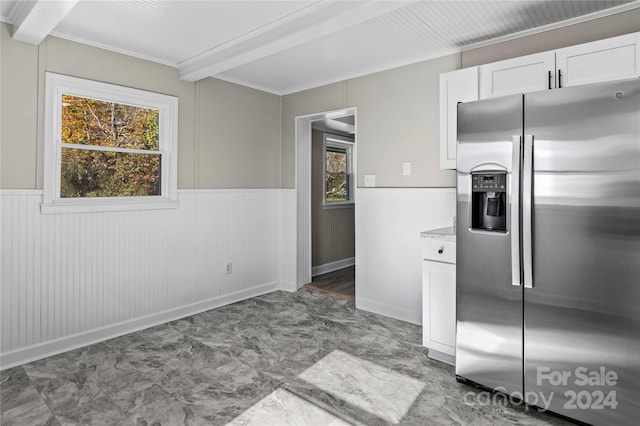 kitchen featuring white cabinetry, stainless steel fridge with ice dispenser, crown molding, and beam ceiling