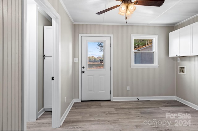 doorway with plenty of natural light, ceiling fan, ornamental molding, and light hardwood / wood-style flooring