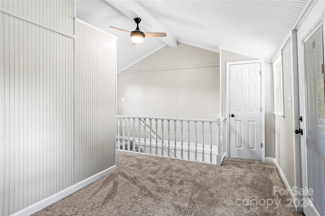 interior space with vaulted ceiling with beams, ceiling fan, and carpet floors