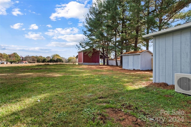 view of yard with ac unit and a storage shed