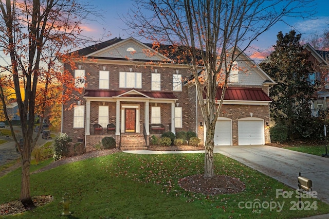157 Montibello Dr, Mooresville, NC 28117 - view of front of home with driveway, brick siding, a lawn, a standing seam roof, and an attached garage