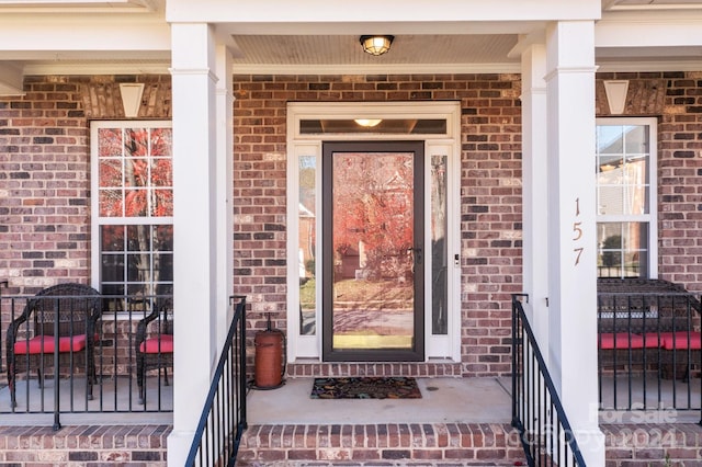 157 Montibello Dr, Mooresville, NC 28117 - view of exterior entry featuring brick siding and a porch