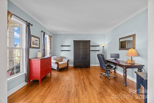 home office with light wood-type flooring and ornamental molding