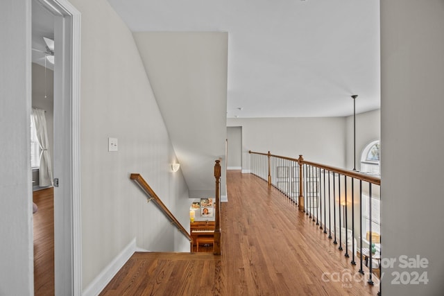 stairs featuring hardwood / wood-style flooring and ceiling fan