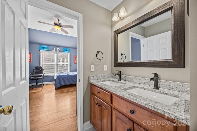 bathroom featuring ceiling fan, hardwood / wood-style floors, and vanity