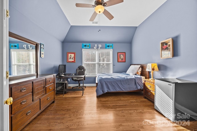 bedroom featuring ceiling fan, hardwood / wood-style floors, and vaulted ceiling