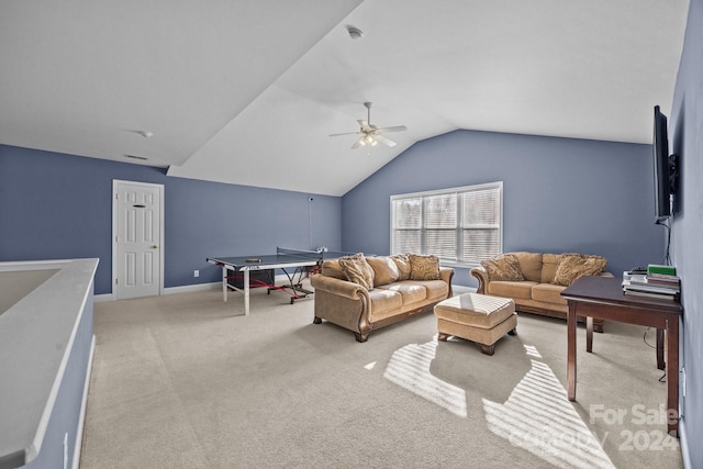 carpeted living room with ceiling fan and vaulted ceiling