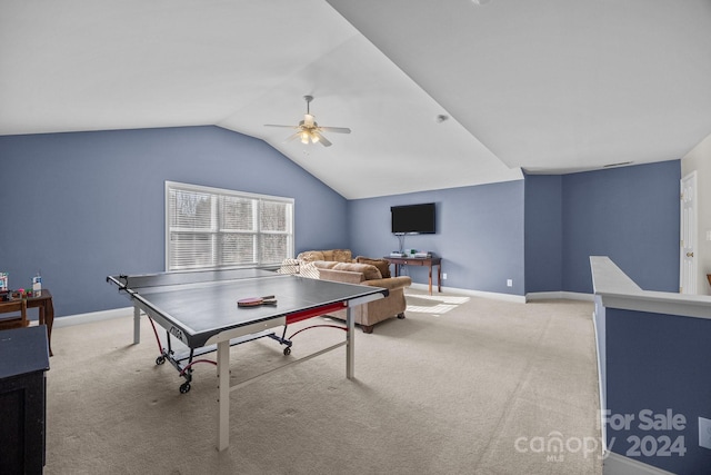 rec room with ceiling fan, light colored carpet, and vaulted ceiling