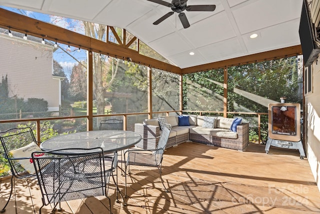 sunroom featuring ceiling fan and vaulted ceiling