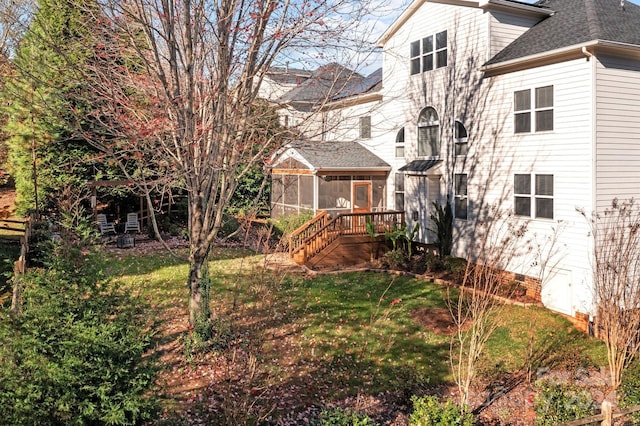 157 Montibello Dr, Mooresville, NC 28117 - back of property with a sunroom, a lawn, and roof with shingles