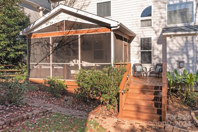 wooden terrace featuring a sunroom