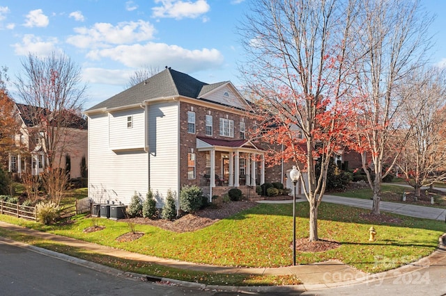 exterior space with a lawn and central air condition unit