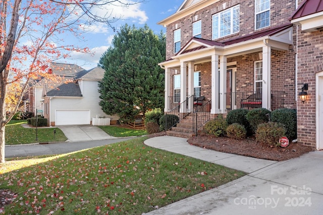 doorway to property with a yard and a garage