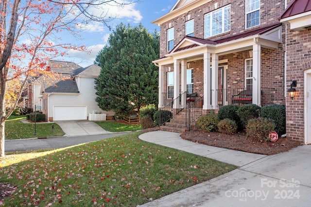 157 Montibello Dr, Mooresville, NC 28117 - doorway to property with brick siding, a garage, a lawn, and a porch