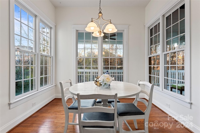 dining space featuring a chandelier and wood-type flooring