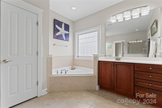 bathroom featuring vanity, tile patterned floors, and independent shower and bath