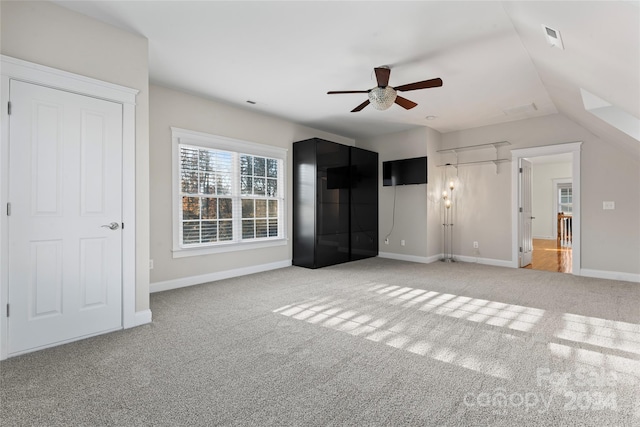 unfurnished bedroom with light colored carpet, ceiling fan, and lofted ceiling