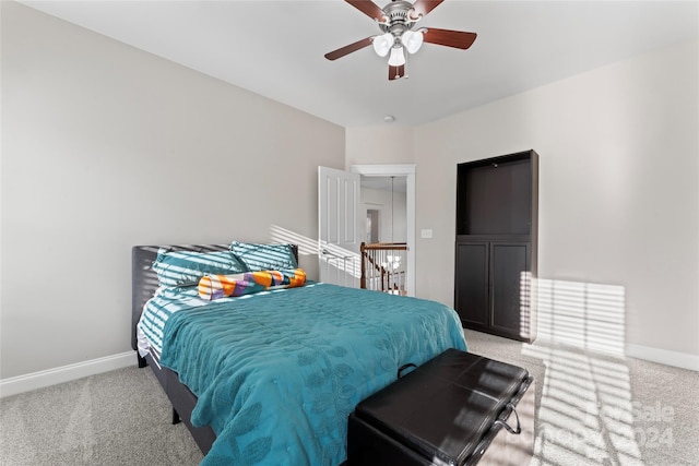 bedroom featuring ceiling fan and light carpet