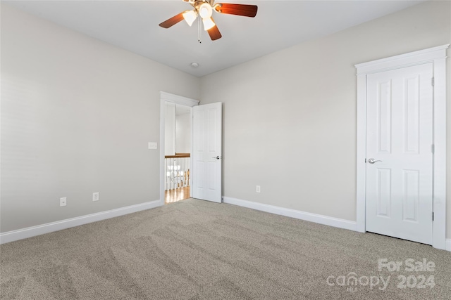 unfurnished bedroom with ceiling fan and carpet floors