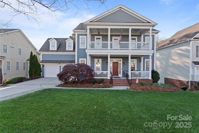 neoclassical / greek revival house with covered porch, a balcony, a garage, driveway, and a front lawn