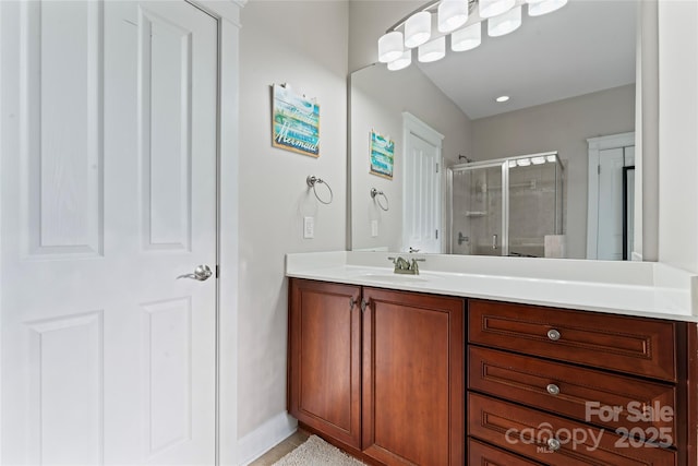 bathroom with a stall shower and vanity