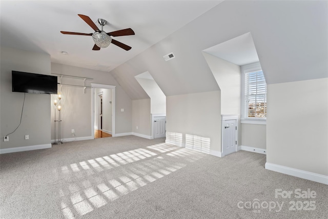 additional living space with lofted ceiling, carpet, visible vents, and baseboards