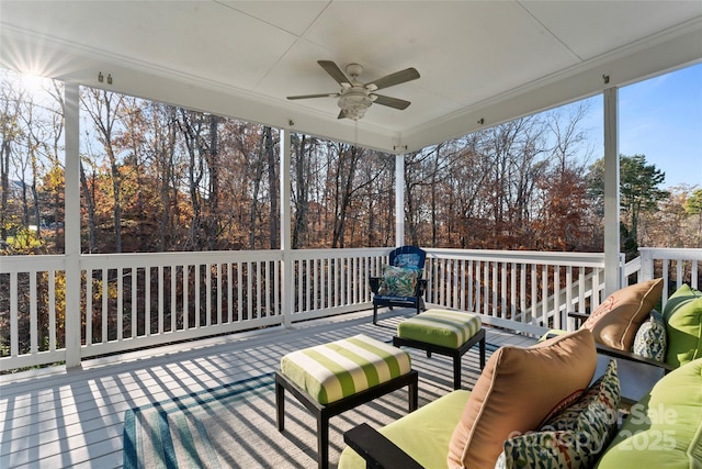 deck with ceiling fan and an outdoor living space