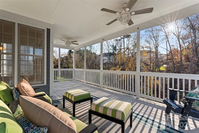 sunroom / solarium featuring ceiling fan