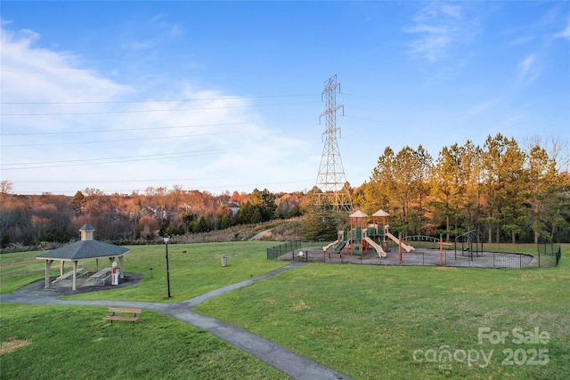 community play area with a yard, fence, and a gazebo