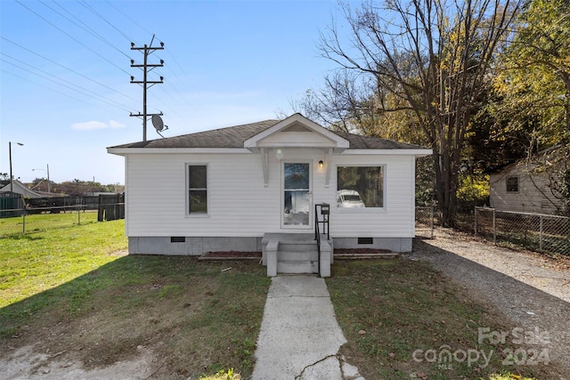 bungalow-style house with a front lawn