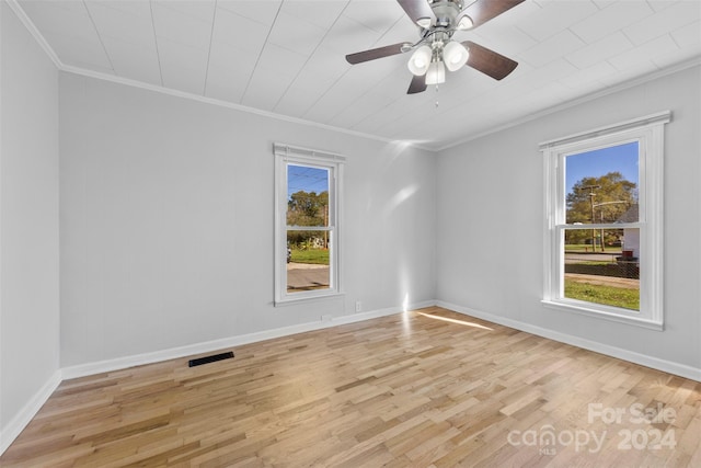 unfurnished room featuring crown molding, a healthy amount of sunlight, and light wood-type flooring