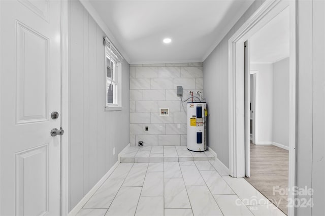 laundry area with electric water heater, washer hookup, and tile walls