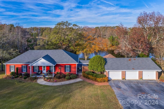 ranch-style house with a front lawn, covered porch, and a garage