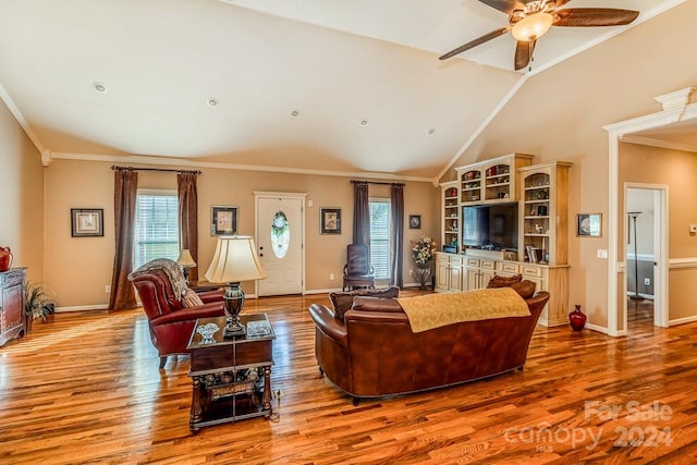 living room with plenty of natural light, hardwood / wood-style floors, and ornamental molding