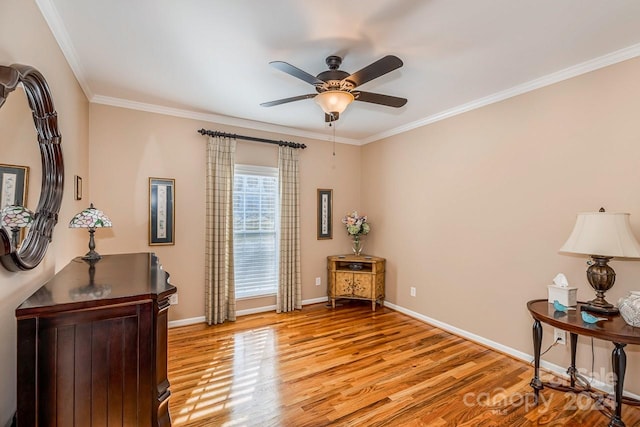 sitting room featuring light hardwood / wood-style floors, ceiling fan, and ornamental molding