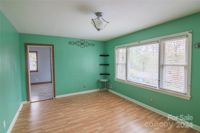 unfurnished room with plenty of natural light and light wood-type flooring