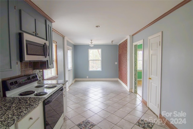 kitchen with white range with electric stovetop, backsplash, light tile patterned flooring, and ornamental molding