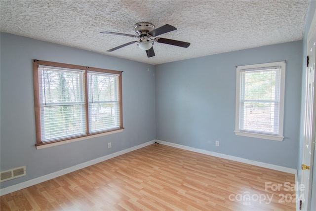 unfurnished room featuring ceiling fan, plenty of natural light, and light hardwood / wood-style floors