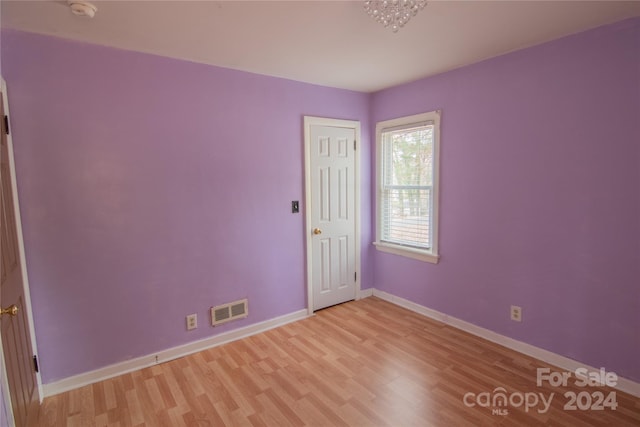 empty room with light hardwood / wood-style floors