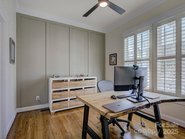 office space with crown molding, light hardwood / wood-style flooring, and ceiling fan