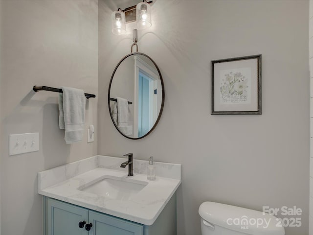 bathroom featuring vanity and toilet