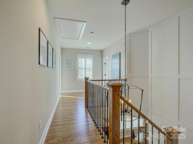 corridor with hardwood / wood-style flooring