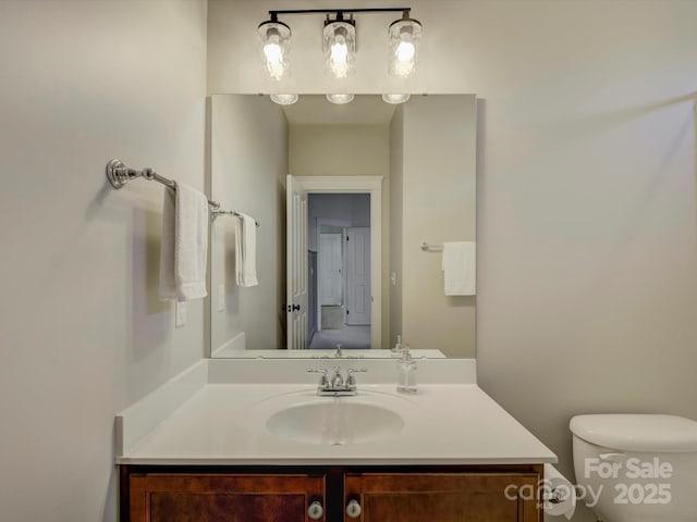 bathroom featuring vanity and toilet