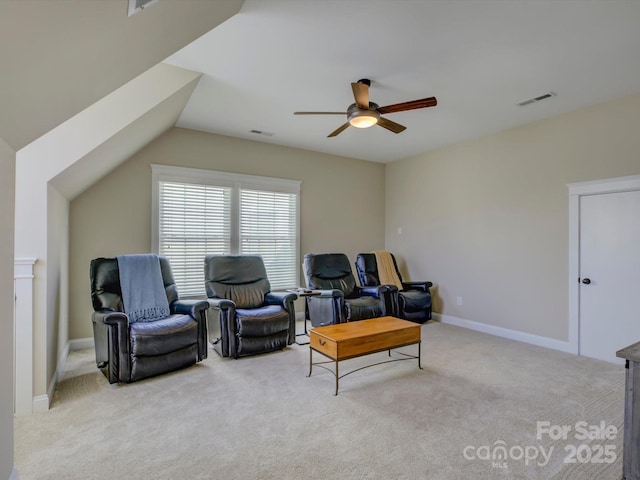 sitting room with ceiling fan, vaulted ceiling, and light carpet